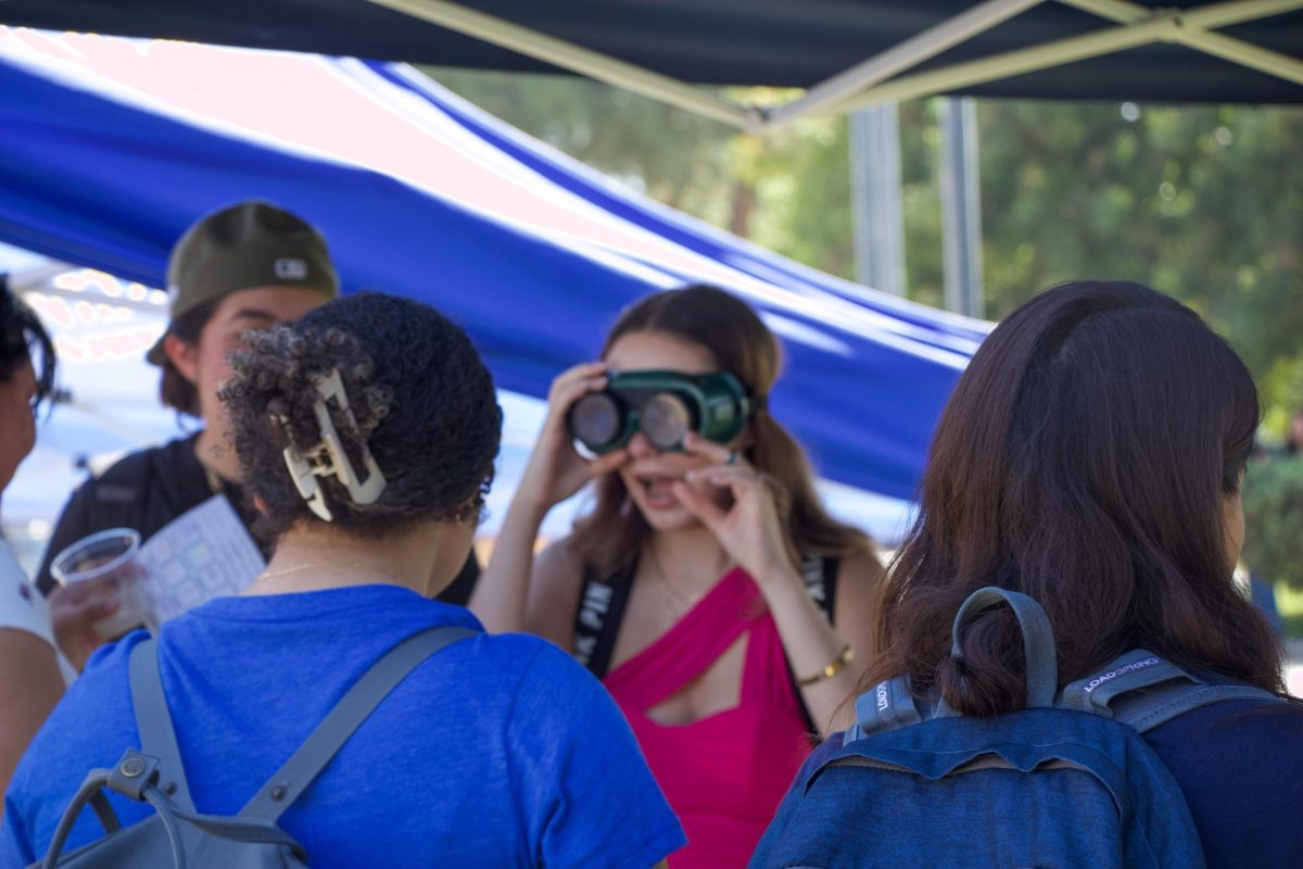 Lizbeth Gomez, Junior at CSUN  studying Human Resources and Business Administration, tries on the beer goggles at the Public Safety tent. “It taught me that if I ever need help that there is someone there,” explained Gomez when asked about her experience.