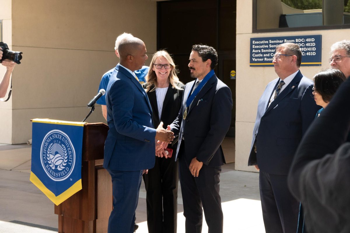 Luis Rangel, CSUB Masters of Business Administration graduate, and Dr. Vernon Harper, interim President of CSUB, at the presidential outstanding graduate student award ceremony on May 13. 