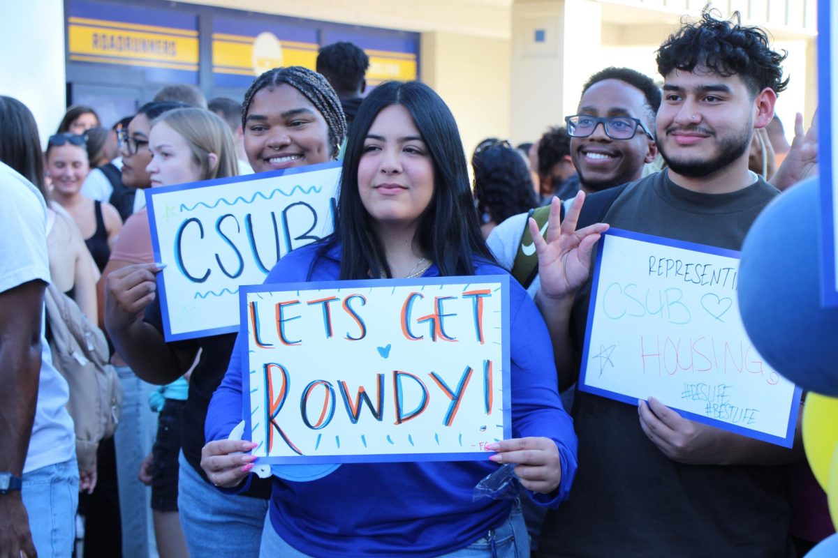 Students before the Welcome Back Pep Rally creating signs to use at the Welcome Back Pep Rally.  