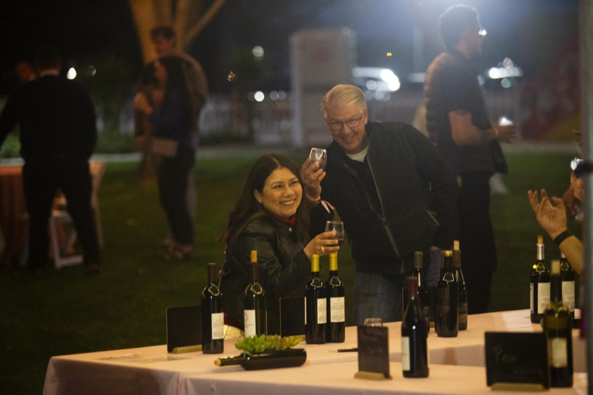 Dr. Gladys Gillam and her husband enjoy wine at the Sip and Scholarship event on Friday March 31. 
