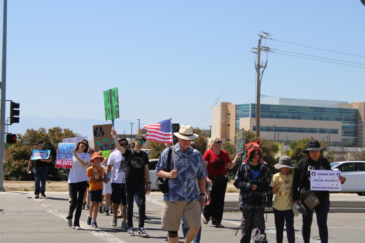 Students, Staff, and Faculty crossing the street protesting