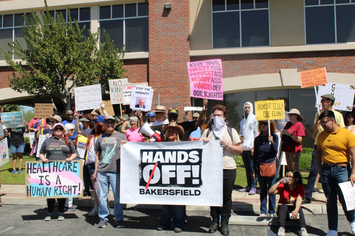 Protesters holding Hands Off sign in front of Vince Fong's office. 