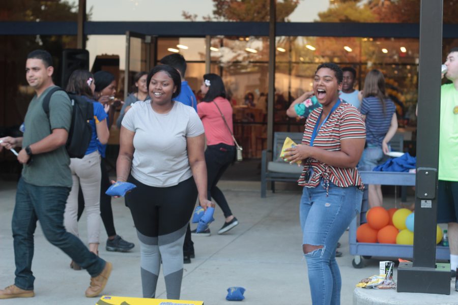 Erykah Jenkins, a Junior Human Biology Major and Dejah Archer, a Junior CAFS major enjoy a game of bean bag tossat the Runner Luau.